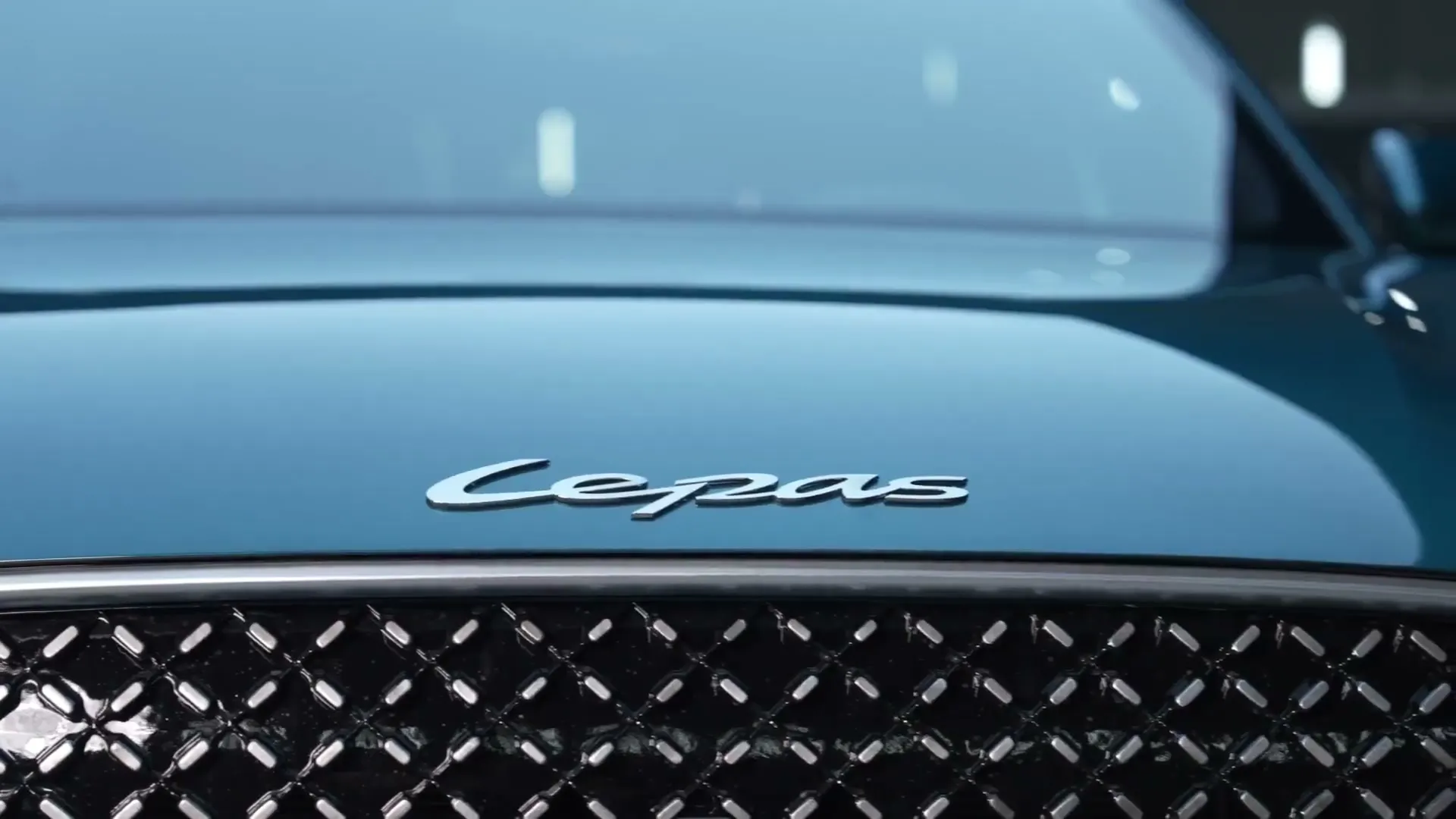 The Lepas badge above the grille of a teal Lepas L8.